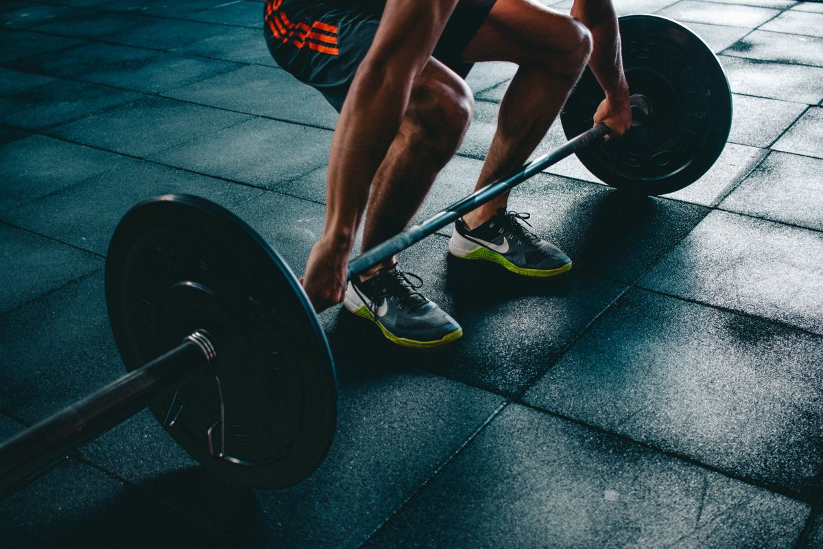 Athlete performing a barbell lift in a gym